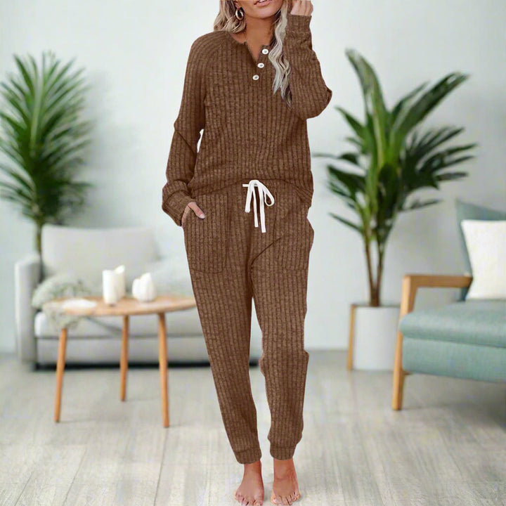 Woman sitting comfortably in a complete women's cozy loungewear set, perfect for rest & relaxation.