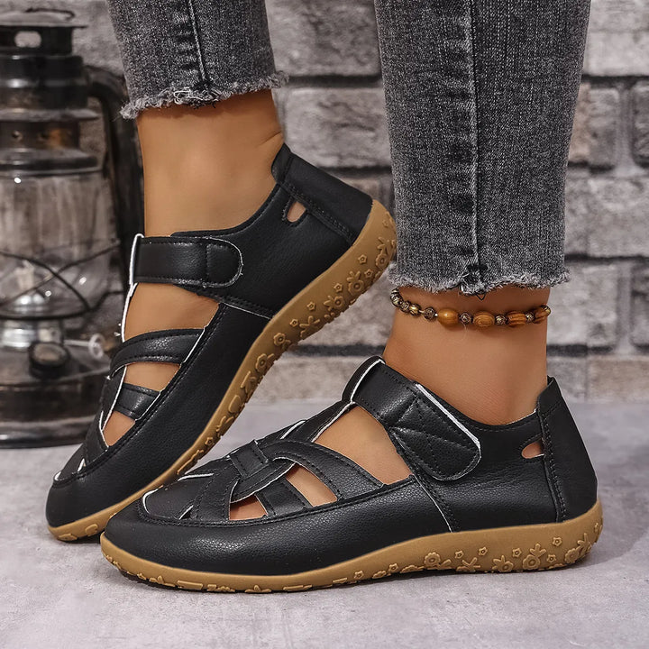 Women's easy-wear cutout sandals with adjustable Velcro straps for comfort and everyday wear.
