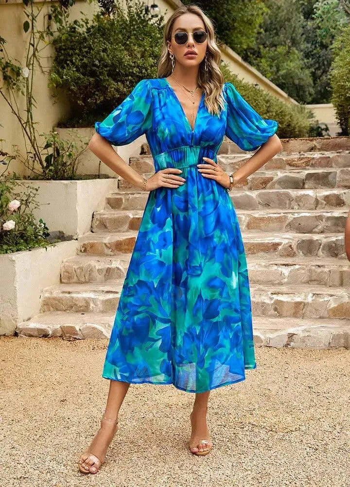 Casual women's midi dress with stylish puff sleeves, cinched waist. Features an abstract print & V-neck.