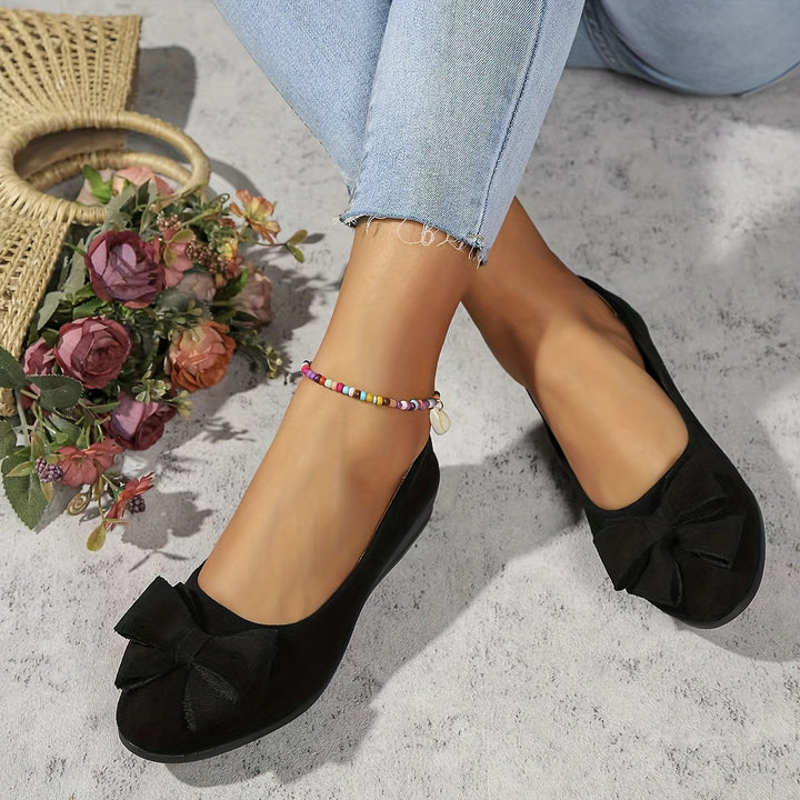 Chic women's everyday wedge flats, slip-on ease and bow accent.