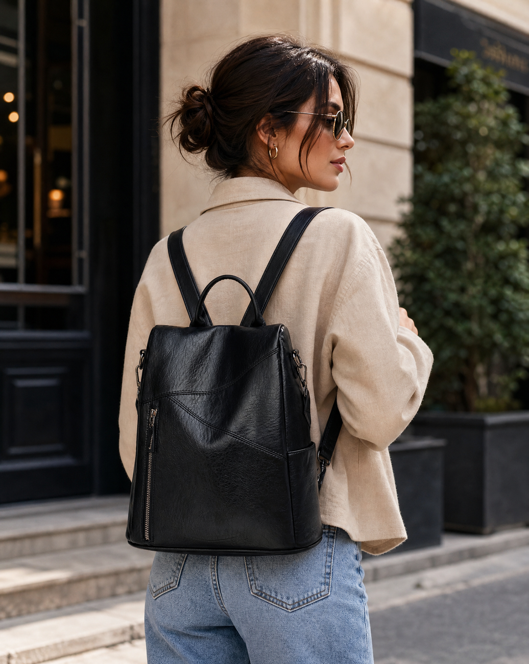 Minimalist urban faux leather backpack, chic women's fashion bag, sleek and structured.