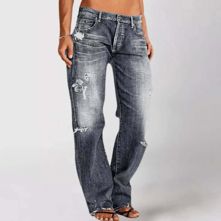Women's mid-rise stretch bootcut jeans in a classic blue wash, providing flattering everyday comfort.