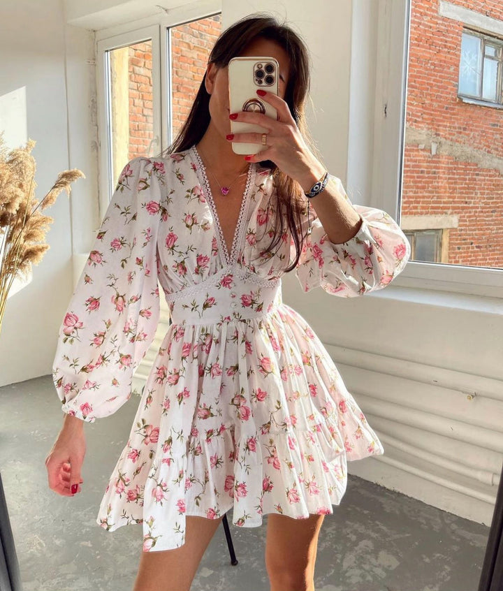 Women's floral V-neck mini dress with long balloon sleeves & tiered skirt, perfect for summer parties.