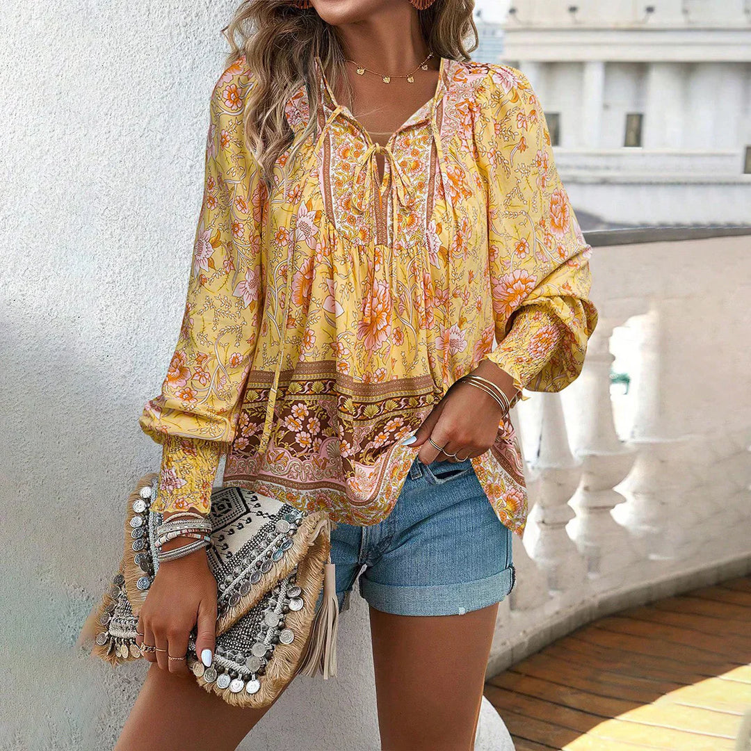 Printed v-neck tie blouse for women. Flowy bohemian long sleeve top, relaxed fit, ideal for spring fashion.