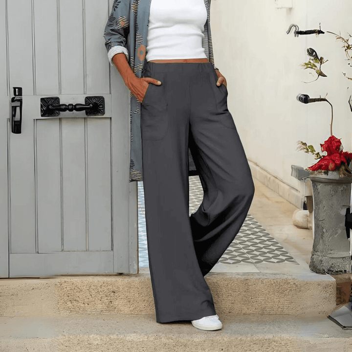 Dark wide-leg women's trousers with a flowy fit & pockets. Chic, comfortable casual pants for versatile all-day wear.