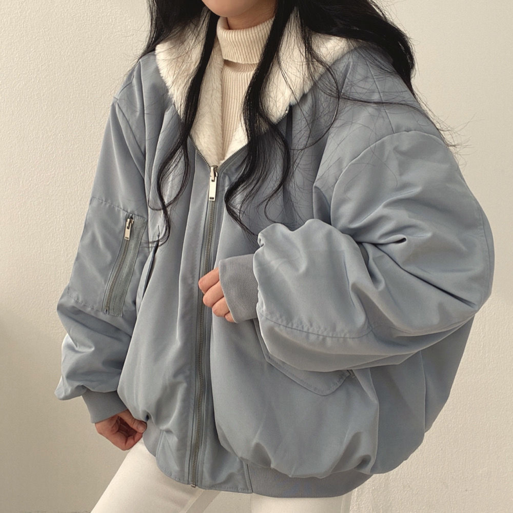 Close-up of hood detail on women's reversible winter jacket, protection from cold weather.