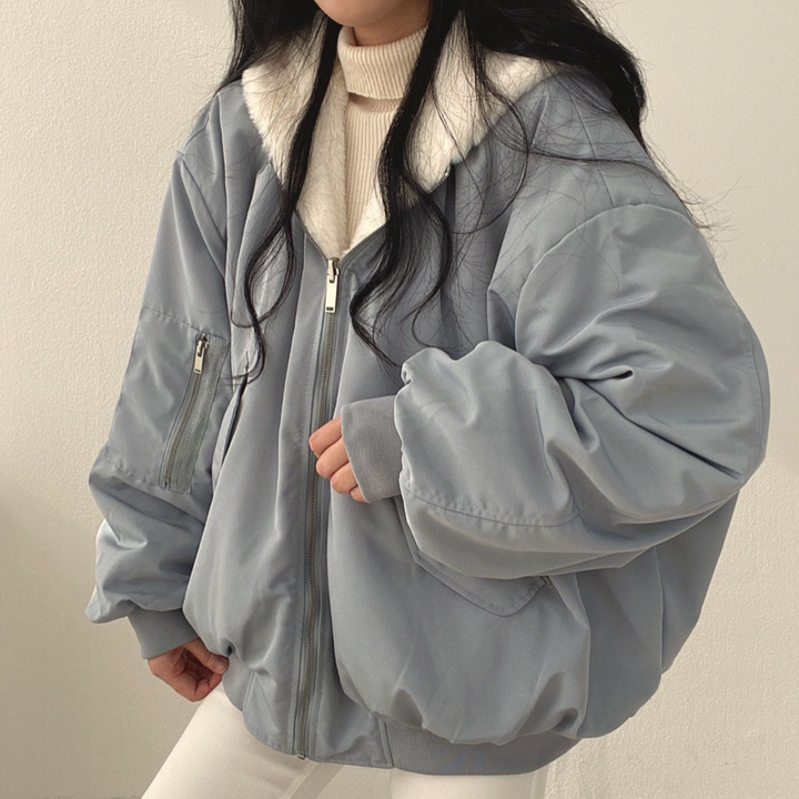 Close-up of hood detail on women's reversible winter jacket, protection from cold weather.