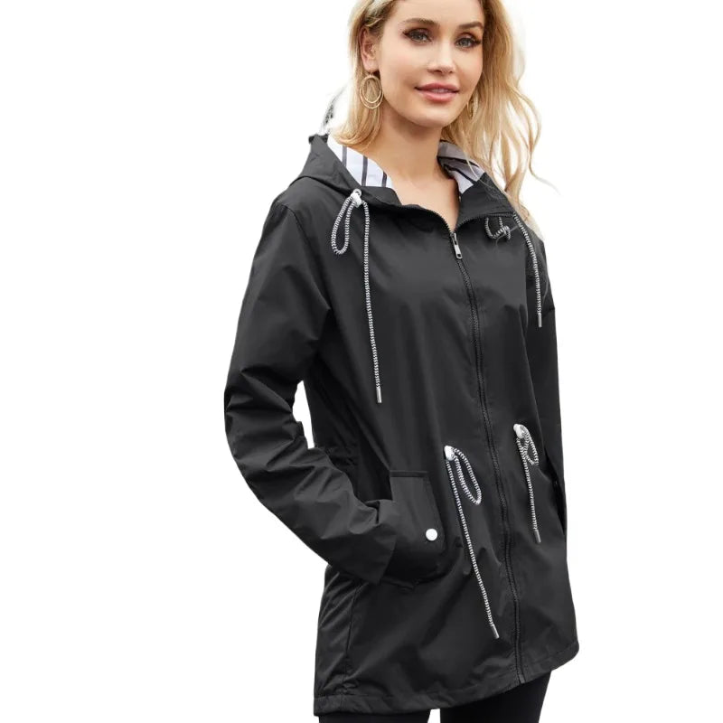 Stylish women's waterproof hooded raincoat, perfect lightweight outerwear for all-weather travel.