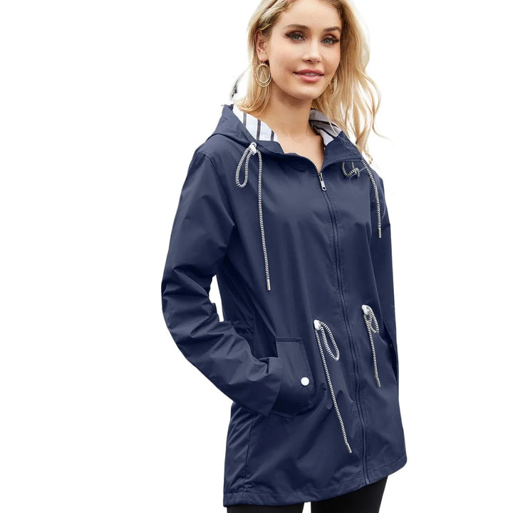 Durable women's hooded waterproof trench coat, lightweight design offers excellent all-weather protection.