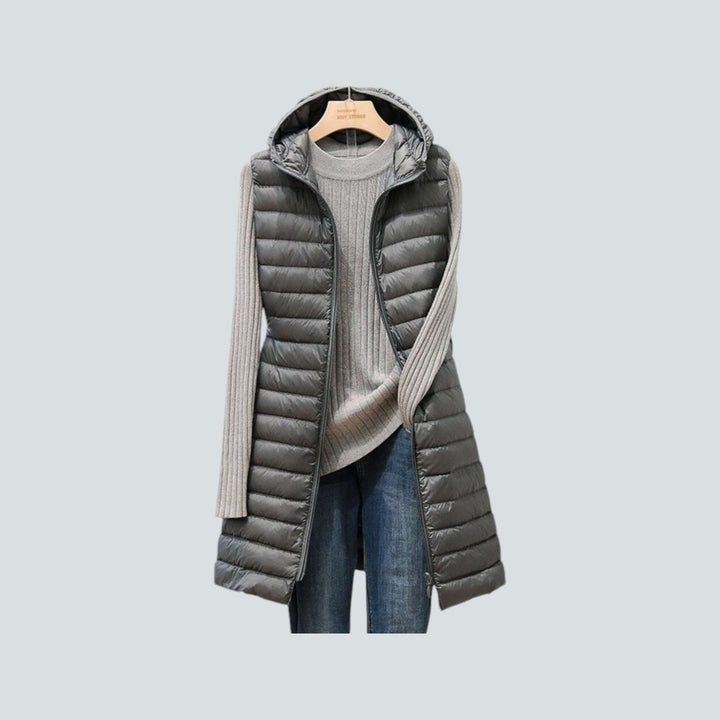 Warm and comfortable women's long quilted puffer vest with effective insulation for superior winter layering.