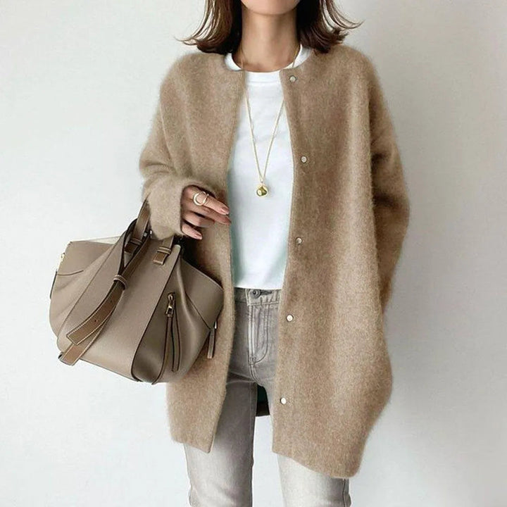 Stylish oversized women's cardigan, longline design with button-up front, perfect for layered fashion & comfort.