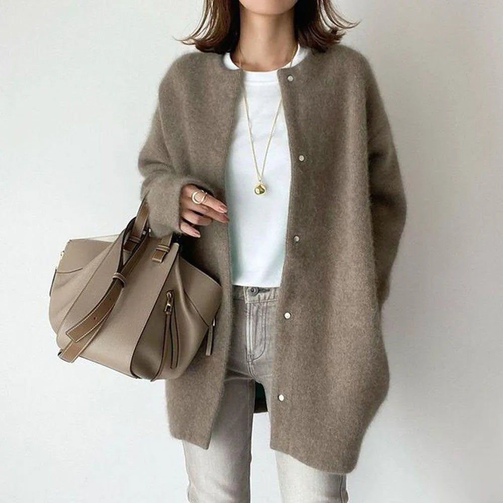 Fashionable women's longline cardigan, oversized and button-up, offering a chic layered look for all seasons.
