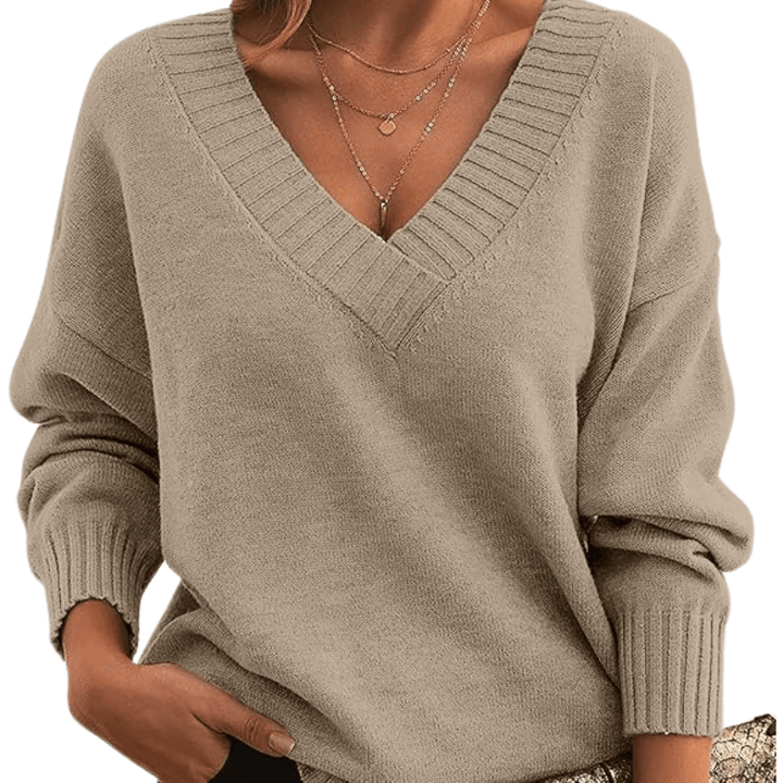 Woman in a soft V-neck cashmere sweater, showcasing elegant premium knitwear detail.