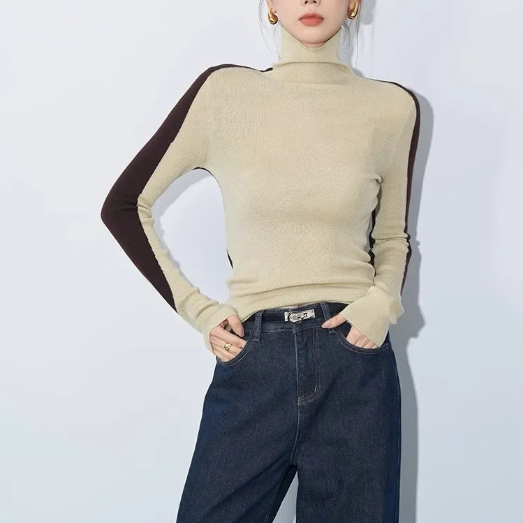 Women's mock neck top with asymmetric contrast long sleeves. Stylish, versatile sweater for casual chic.