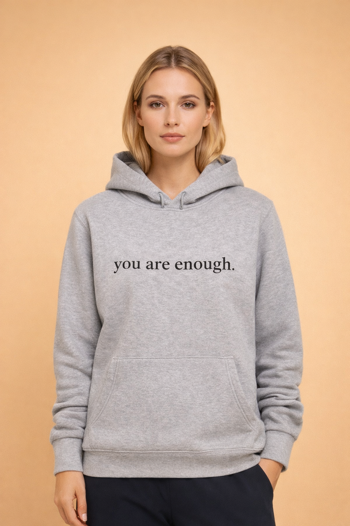 Soft pink women's oversized hoodie, a cozy statement piece with a positive slogan for comfort.