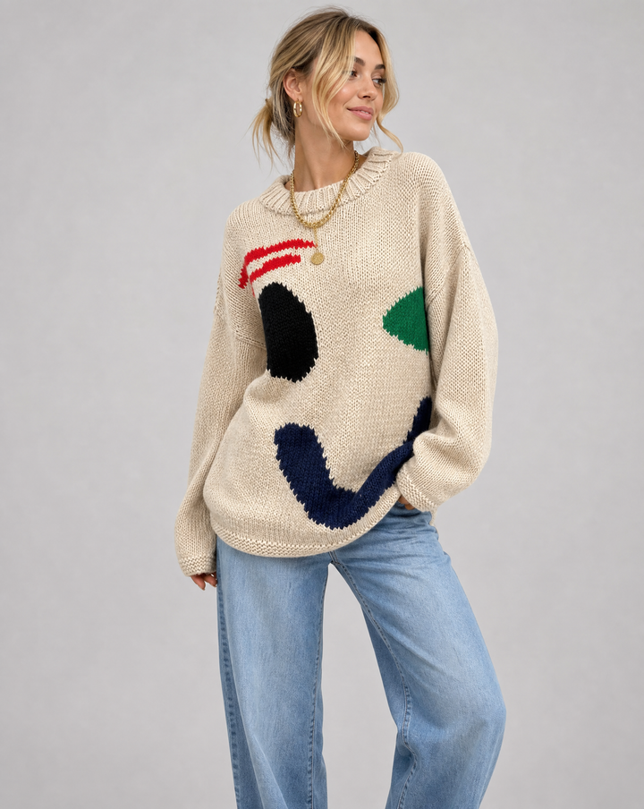 Women's oversized smiley face sweater, cozy knit pullover for autumn fashion.