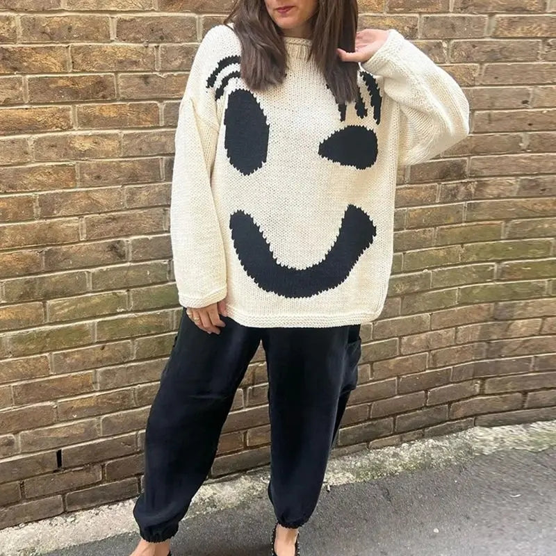 Trendy women's oversized smiley face knit sweater, cozy pullover for comfortable style.