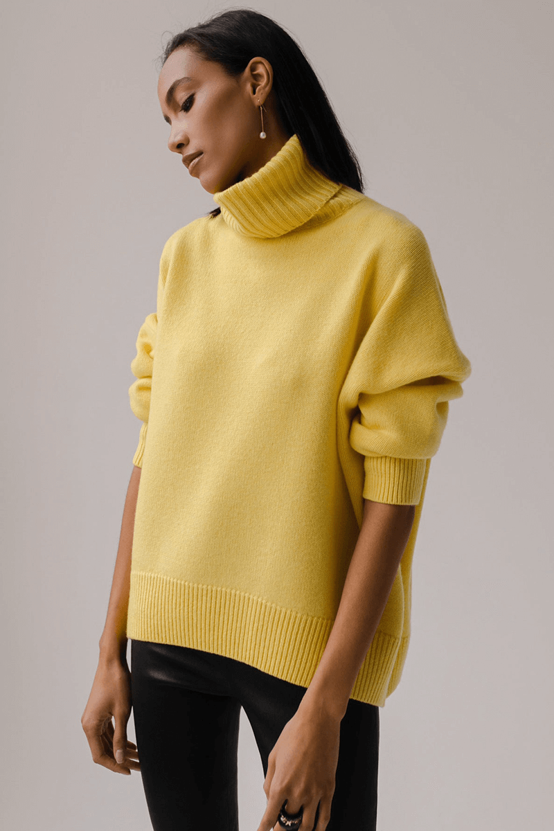 Stylish women's oversized knit pullover, featuring a warm turtleneck and relaxed fit for winter fashion.