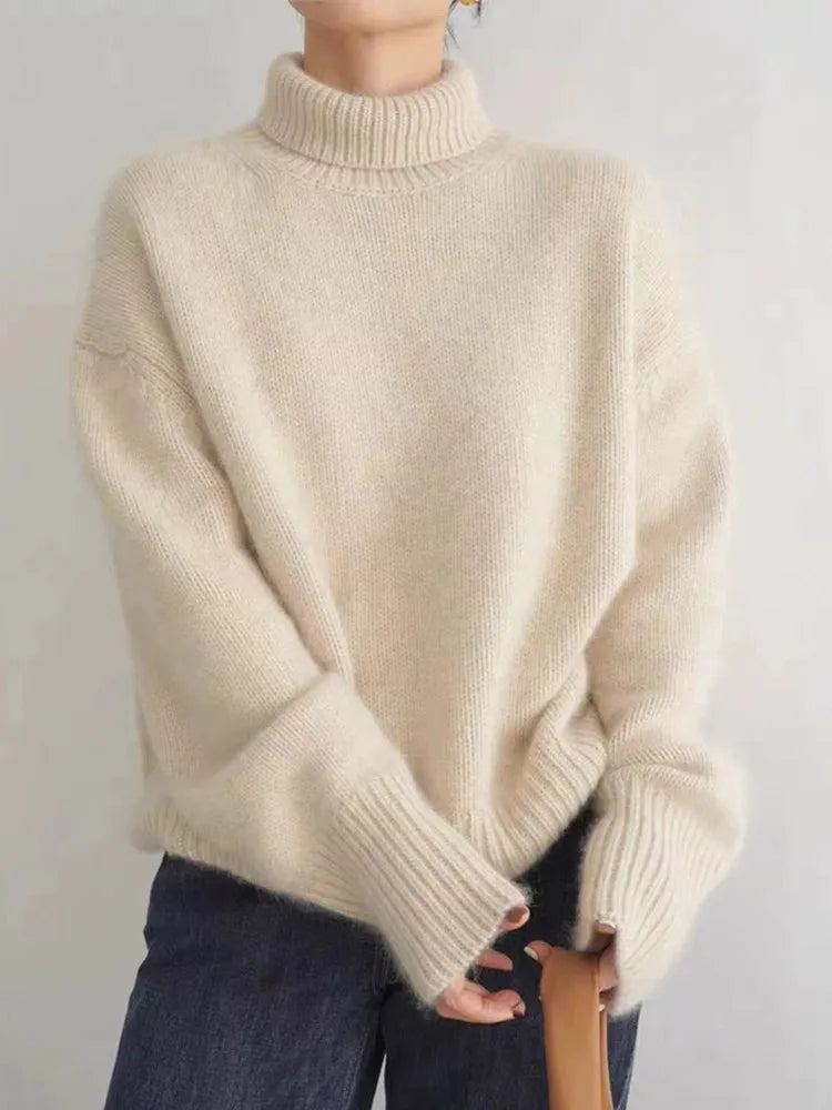 Elegant and cozy women's oversized turtleneck sweater, a stylish knit for winter fashion comfort.