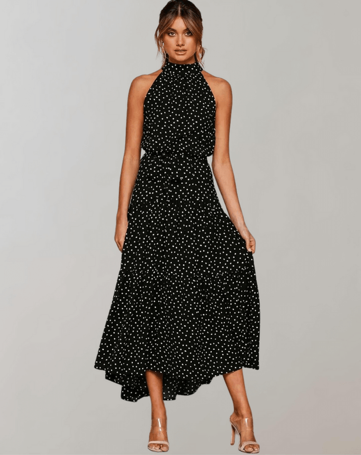 Versatile women's polka dot halter maxi dress, ideal for casual or elegant summer looks.