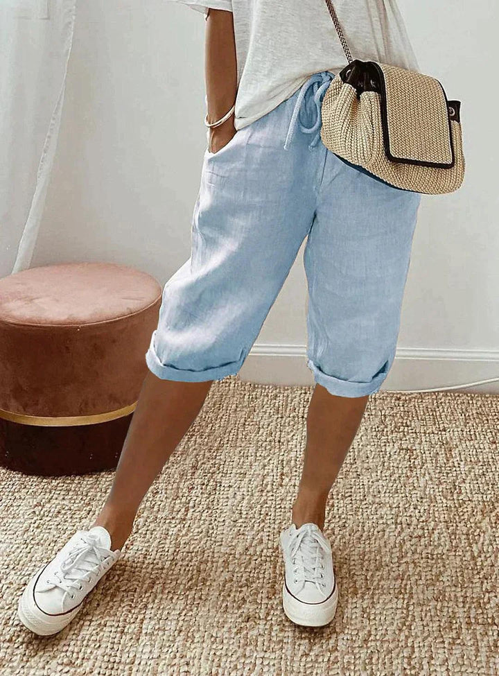 Chic women's loose fit linen capri pants with stretch waist. Perfect for comfortable everyday summer fashion.