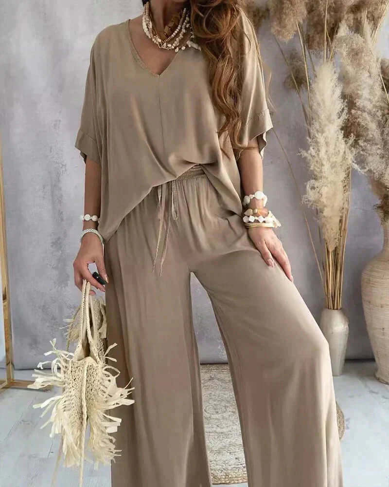 Stylish women's relaxed loungewear set, a comfortable two-piece featuring a V-neck top & wide-leg pants for casual wear.
