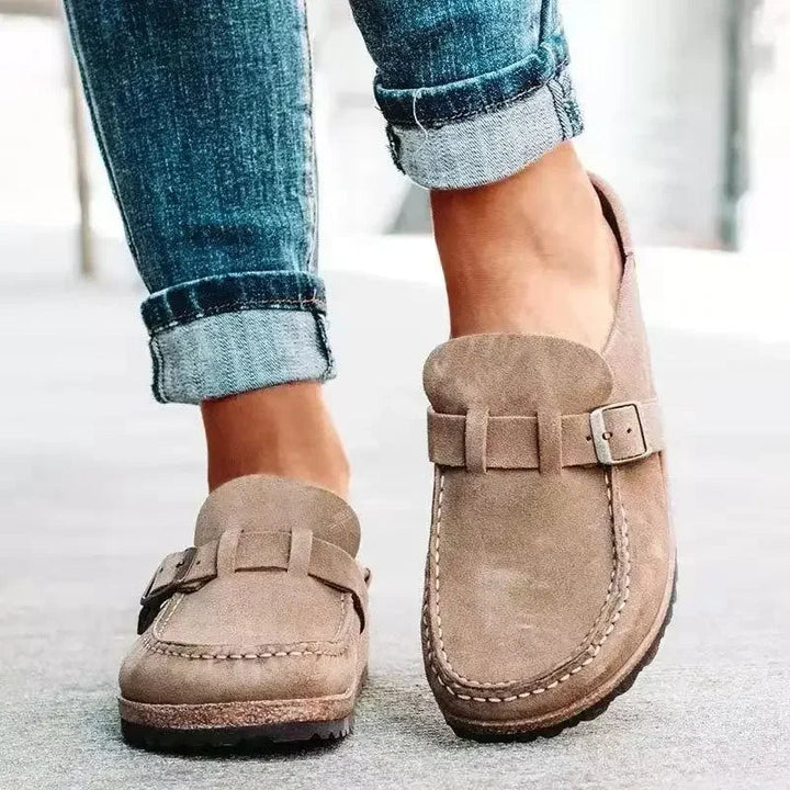 Trendy women's retro buckle flat mules. Comfortable slip-on shoes for everyday casual wear and effortless style.