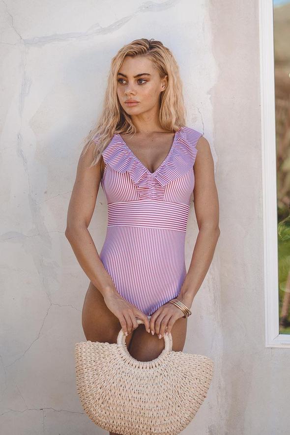 Vibrant retro striped swimsuit for women. Perfect summer fashion beachwear & vacation essential. New collection.