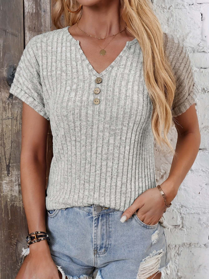 Detailed women's ribbed knitted henley top, long sleeve with button placket, relaxed fit.