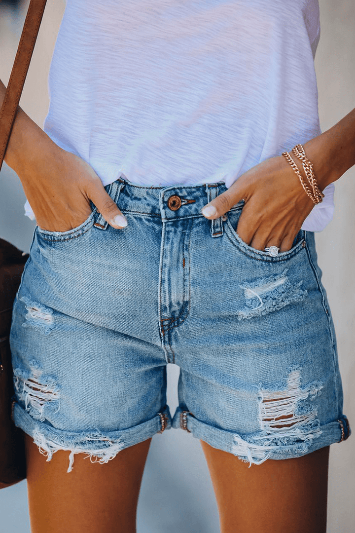 Women's ripped denim shorts with stylish fringes, perfect for summer fashion & casual wear.