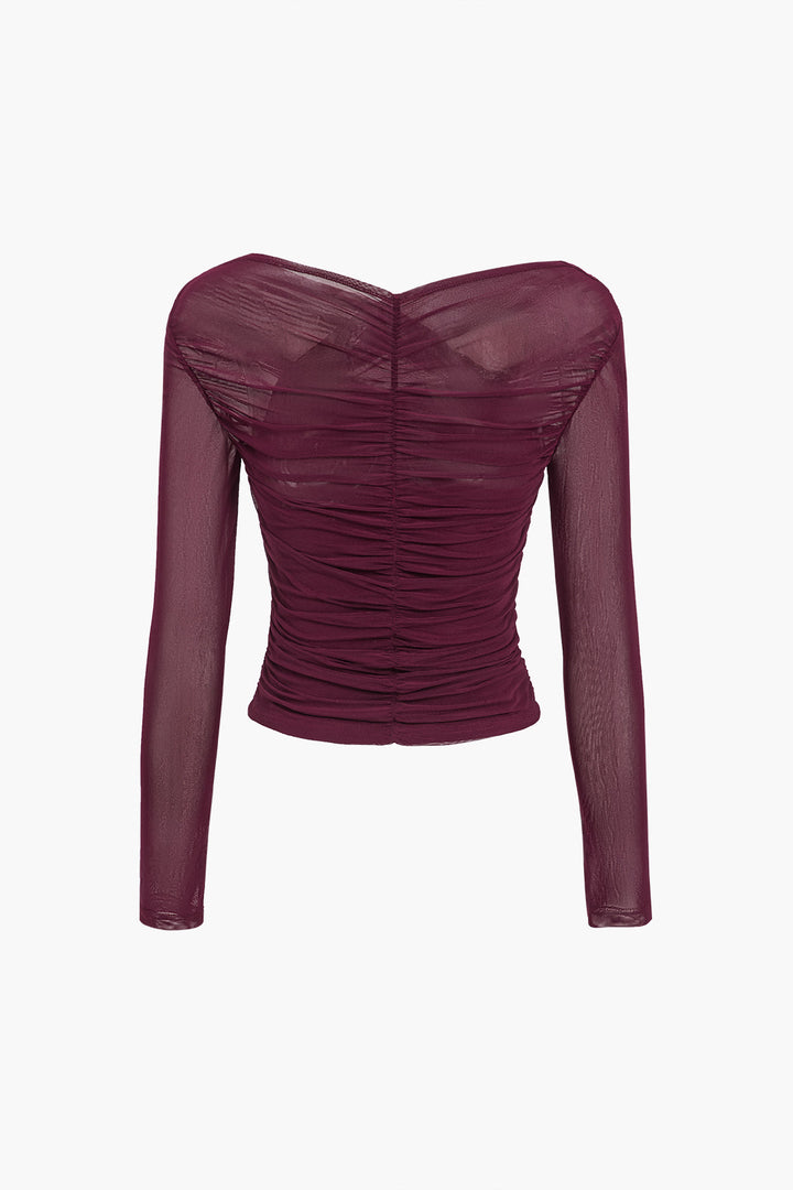 Elegant sheer mesh top with sophisticated ruching, a modern long sleeve blouse for women.