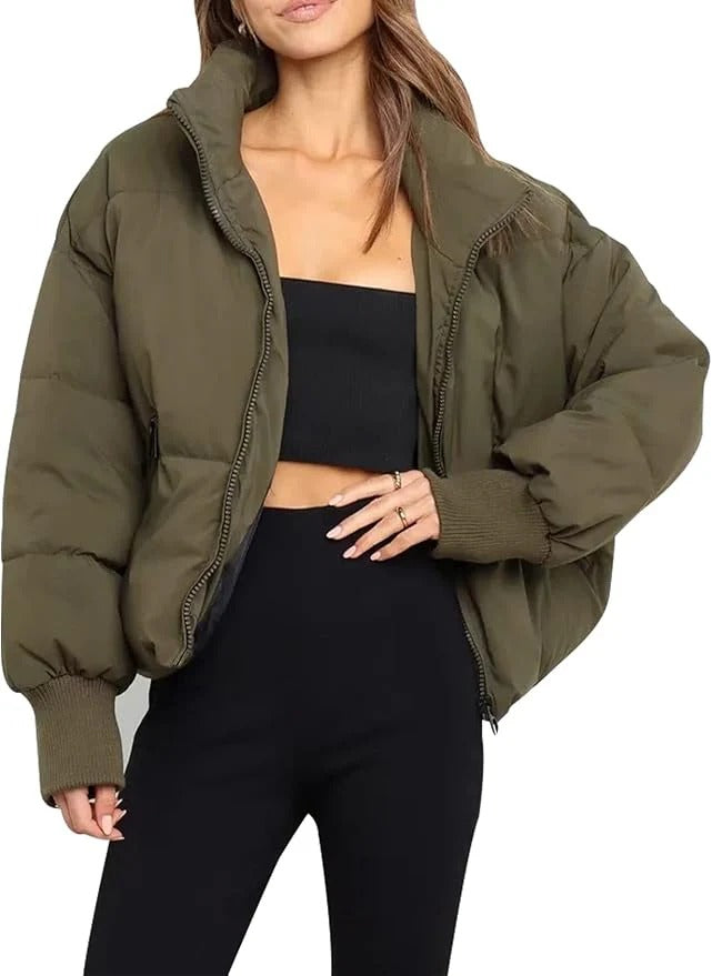 Women's modern short quilted puffer jacket with a convenient front zipper, perfect for chilly weather.