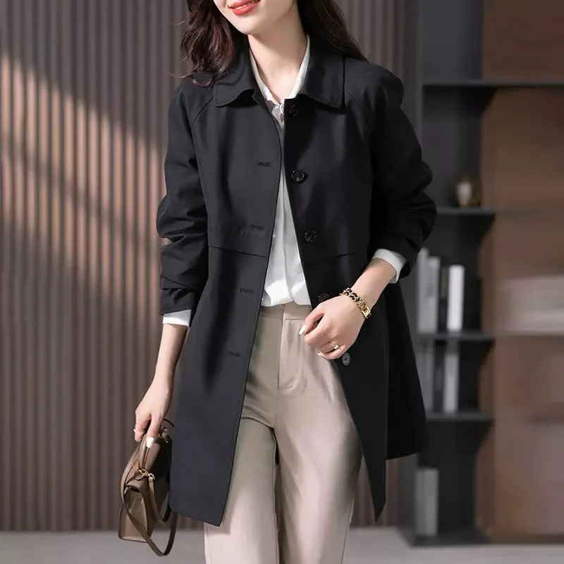 Woman wearing a button-up short trench coat. Stylish outerwear for everyday elegance and work.
