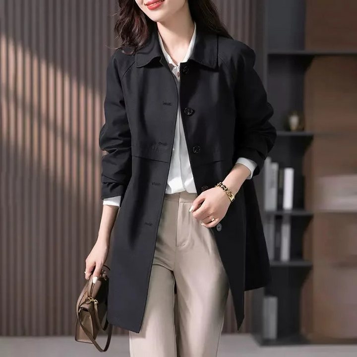 Woman wearing a button-up short trench coat. Stylish outerwear for everyday elegance and work.