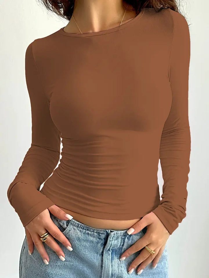 Stylish women's long sleeve top with a modern slim fit. Elevates any casual or fashion-forward look.