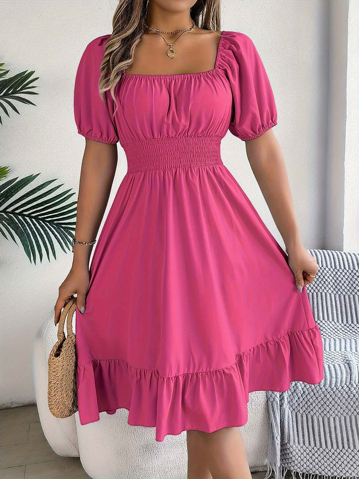 Casual women's day dress: Smocked, puff sleeve, A-line midi style in a breathable rayon blend.