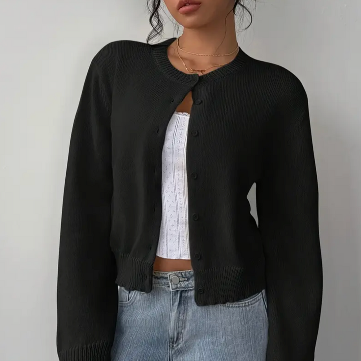Soft knit women's cropped cardigan, featuring button-up front & ribbed hem.