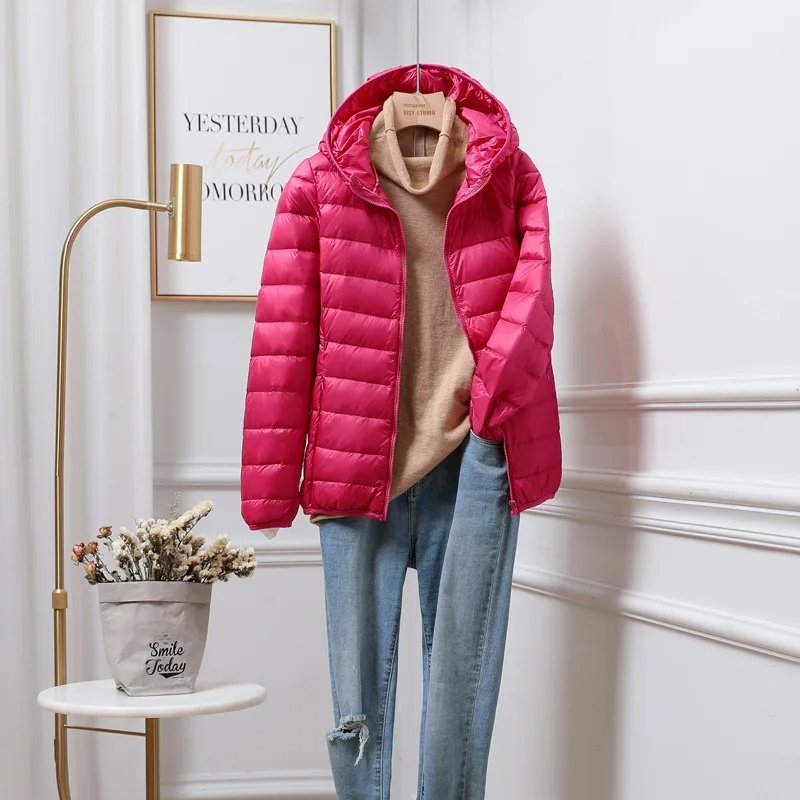 Women's ultralight hooded puffer jacket with zip pockets, practical for everyday use.