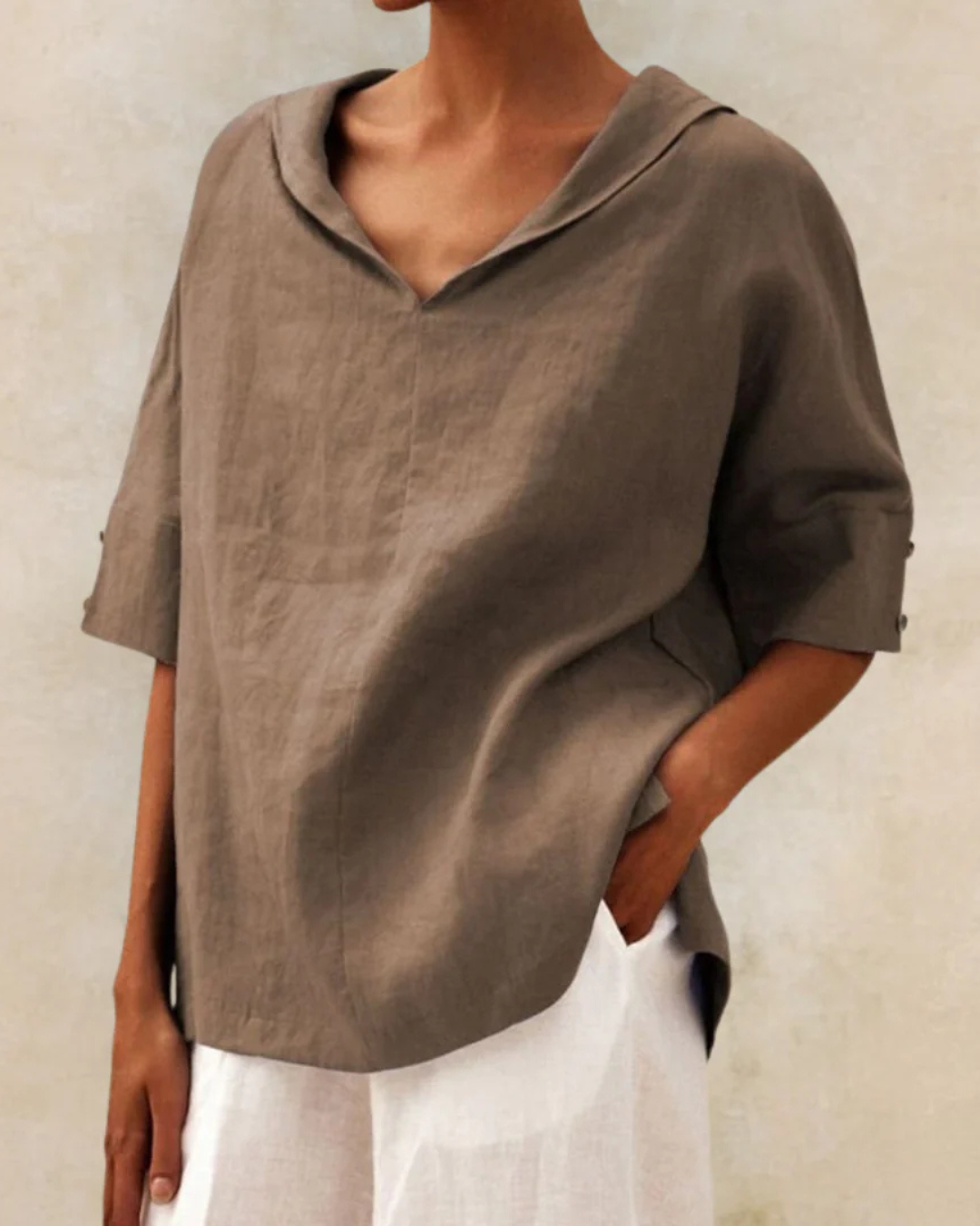 Chic women's V-neck linen blouse, designed with comfortable half sleeves for warm weather fashion.