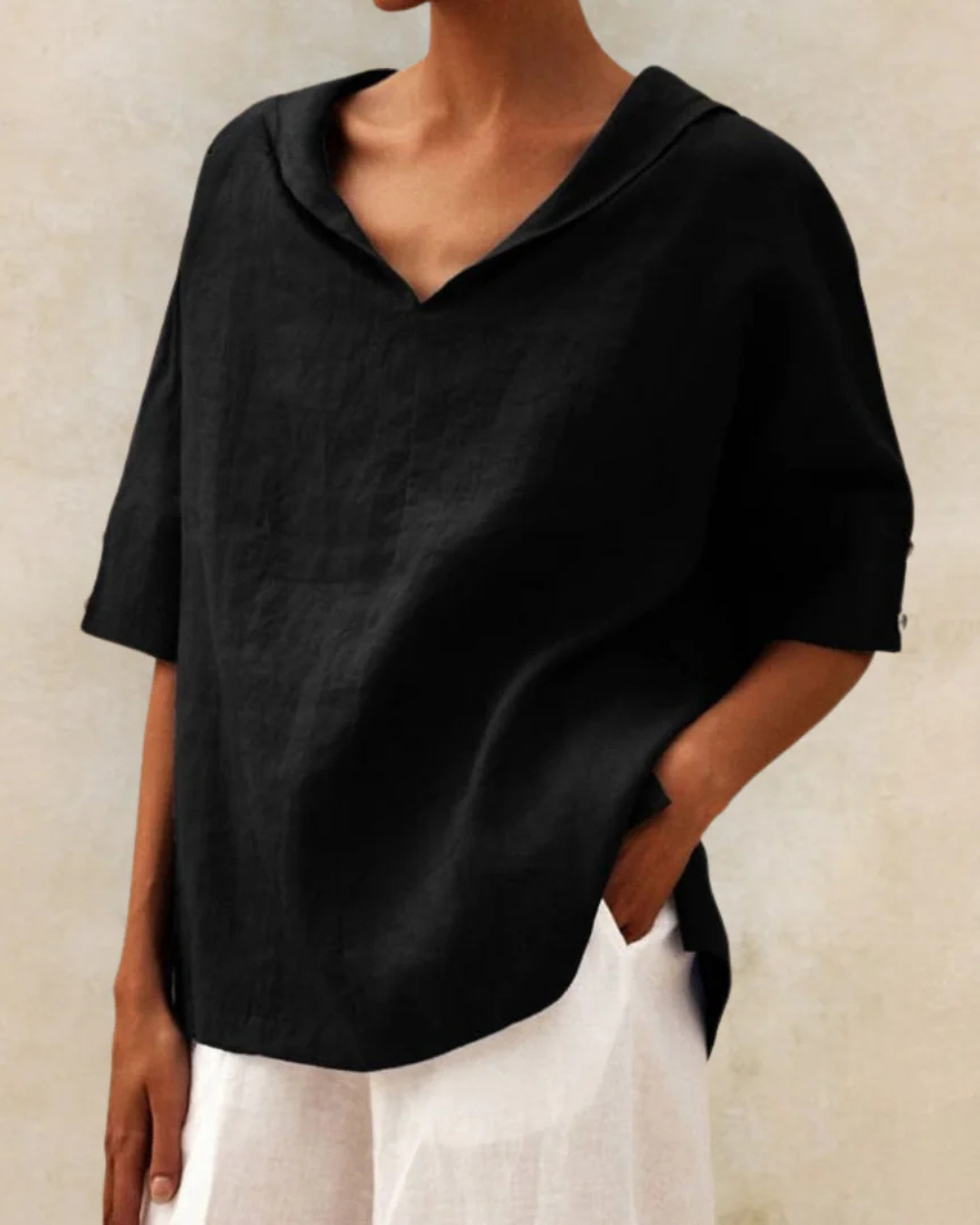 Textured linen V-neck blouse for women, showcasing breathable fabric and half sleeves for chic summer fashion.