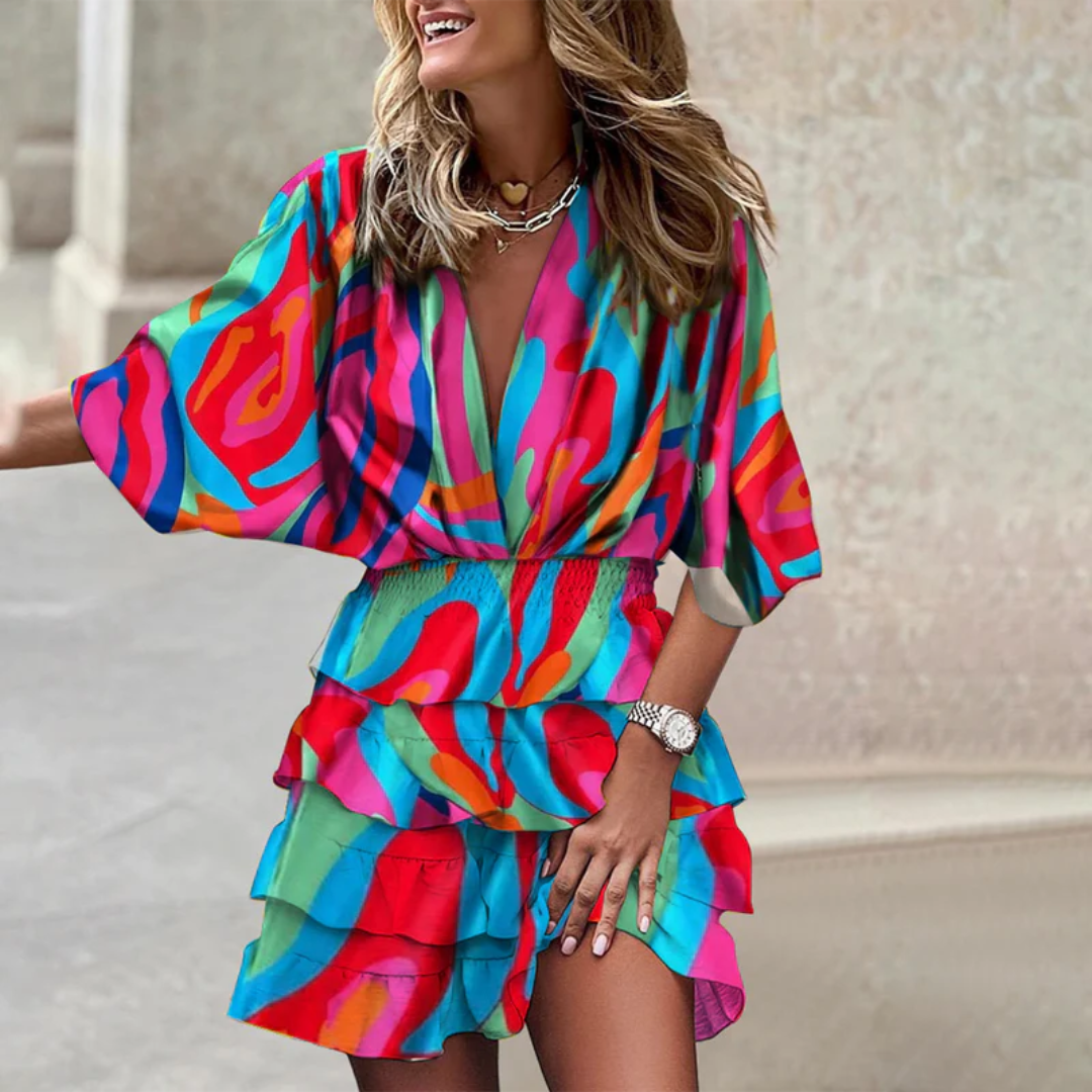 Eye-catching vibrant mini dress. Women's flattering sleeveless summer dress with cheerful colorful patterns.
