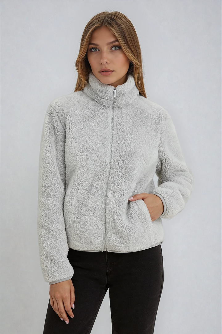 Women's comfortable fleece jacket in a versatile neutral tone, great for everyday warmth.