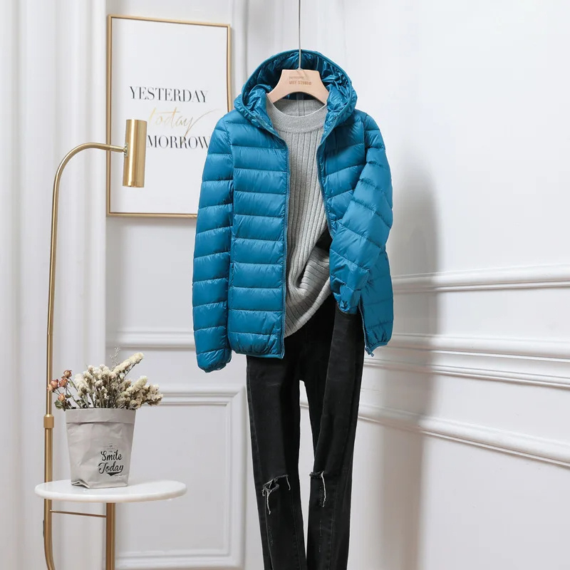Warm women's hooded puffer jacket, insulated and zip-up, ideal for cold autumn & winter days.