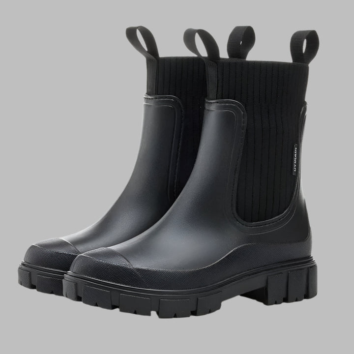 Classic black women's waterproof Chelsea rain boots, sleek design, slip-on for ultimate wet weather protection & style.