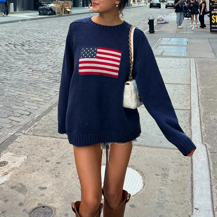 Women's blue sweater with American flag print, featuring relaxed fit and vibrant design for stylish, casual wear.